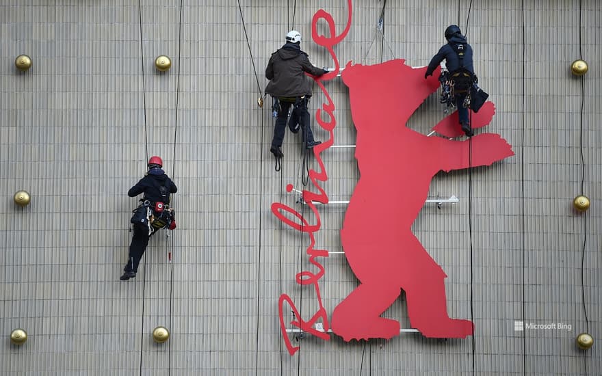 Industrial climbers climb the Berlinale bear in the Zoo-Palast cinema, Berlin