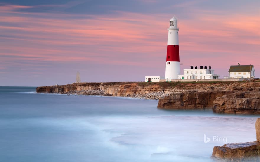 Dawn sunlight and waves at Portland Bill Lighthouse, Dorset, England